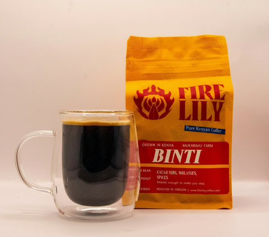 Fire Lily Binti coffee bag with a glass of coffee on a white background