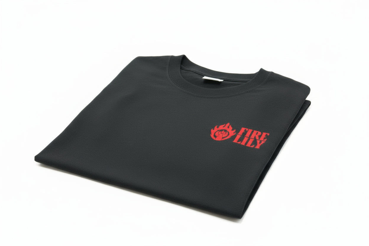 Folded black shirt with 'Fire Lily' logo on a white background